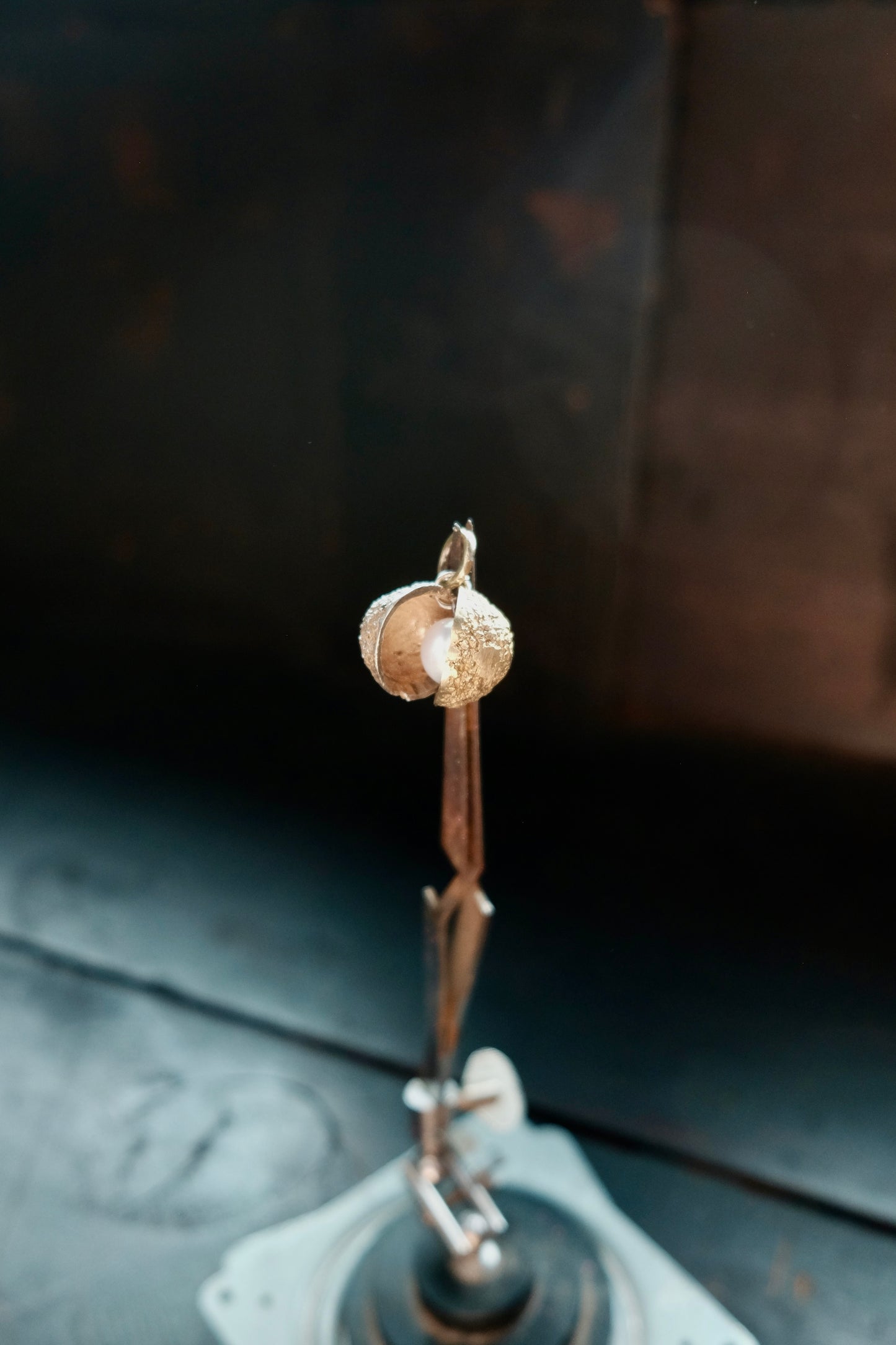 Charm nut with a pearl in silver and brass